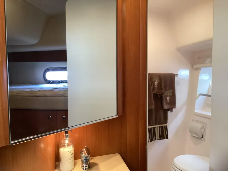 Slide: The Image of 2004 Tiara Yachts 4400 Sovran bathroom with mirror, sink, and towels. - 13
