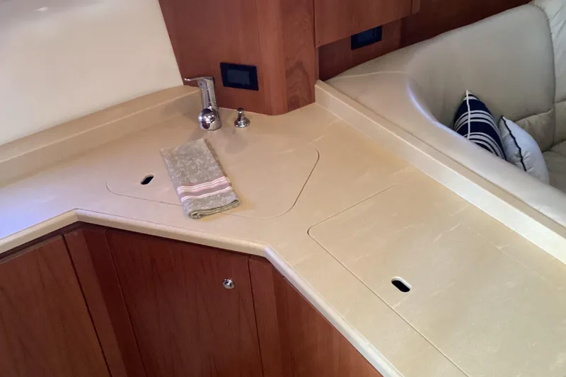 Slide: The Image of 2004 Tiara Yachts 4400 Sovran interior with sleek kitchen counter and sink. - 16