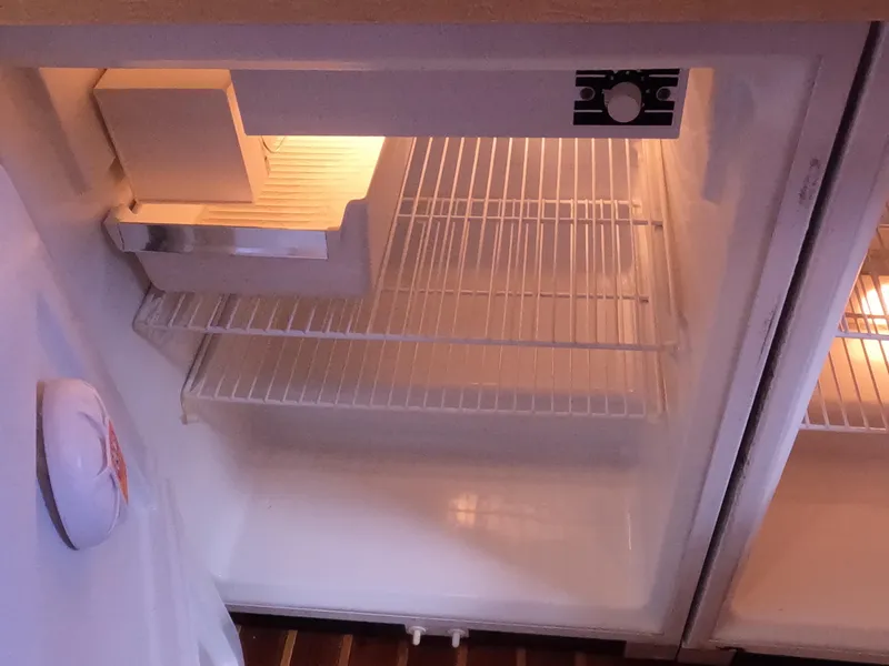 Slide: The Image of Empty refrigerator inside a 2004 Tiara Yachts 4400 Sovran. - 17