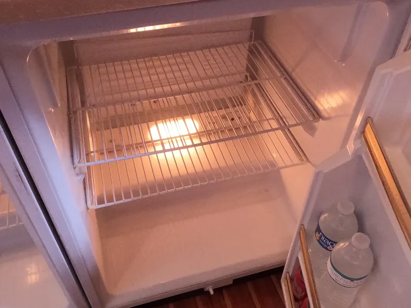 Slide: The Image of Empty refrigerator interior on a 2004 Tiara Yachts 4400 Sovran. - 18
