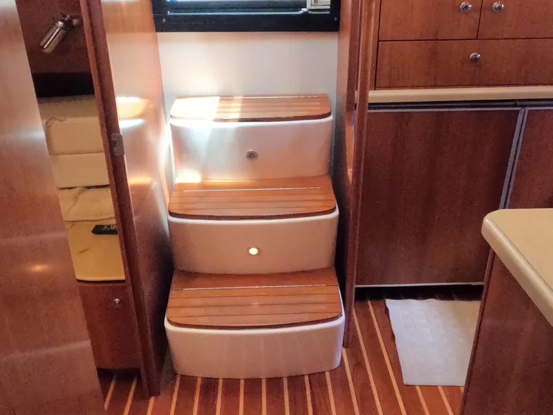 Slide: The Image of Interior stairs of 2004 Tiara Yachts 4400 Sovran with wooden steps and modern design. - 22