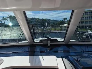 Slide: The Image of Interior view from 2004 Tiara Yachts 4400 Sovran, showcasing marina and palm trees. - 26