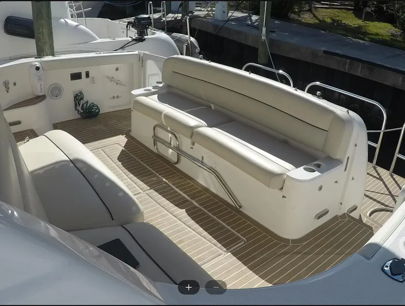 Slide: The Image of 2004 Tiara Yachts 4400 Sovran cockpit with cushioned seating and teak flooring. - 36