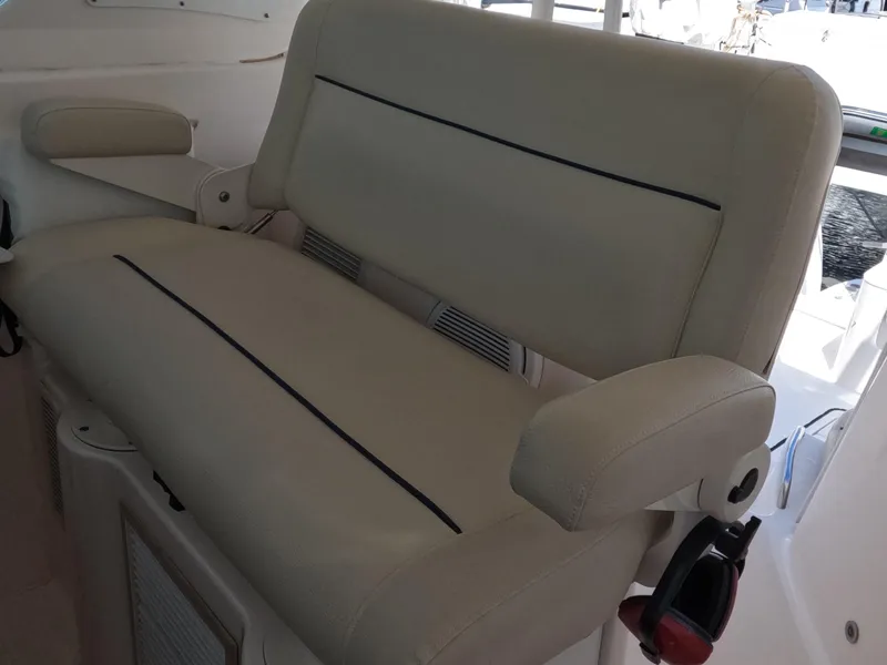 Slide: The Image of 2004 Tiara Yachts 4400 Sovran beige seating with armrests on deck. - 39