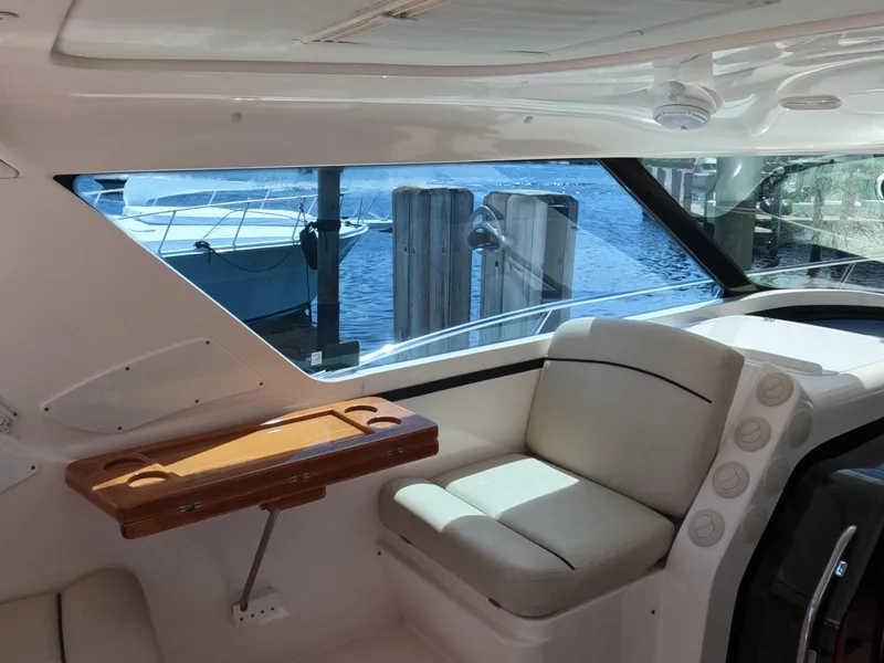 Slide: The Image of Interior of 2004 Tiara Yachts 4400 Sovran with seating and window view of marina. - 40