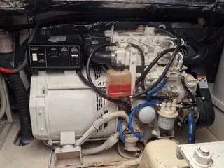 Slide: The Image of Engine compartment of 2004 Tiara Yachts 4400 Sovran, showcasing mechanical components and wiring. - 44