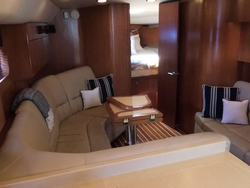 Slide: The Image of Luxurious interior of 2004 Tiara Yachts 4400 Sovran with cozy seating and elegant wood finishes. - 7