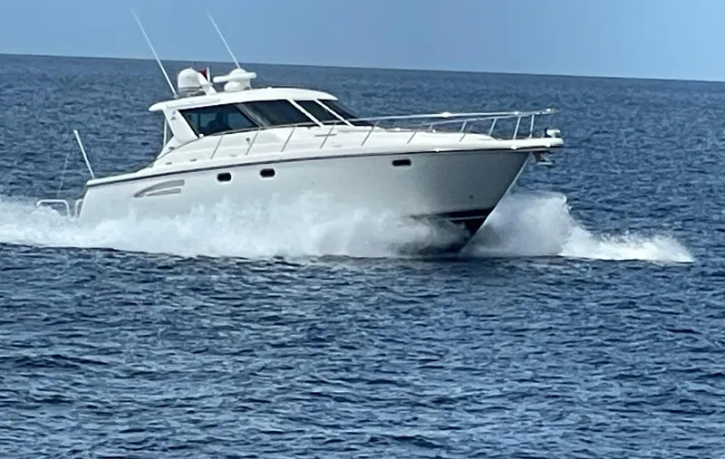 Slide: The Image of 2004 Tiara Yachts 4400 Sovran cruising on open water. - 93