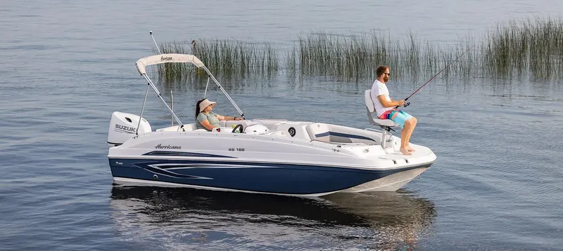 Slide: The Image of 2021 Hurricane 188 SunDeck Sport CC-OB boat on calm water, two people fishing. - 12