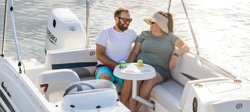 Slide: The Image of Couple relaxing on a 2021 Hurricane 188 SunDeck Sport CC-OB boat, enjoying a sunny day. - 14
