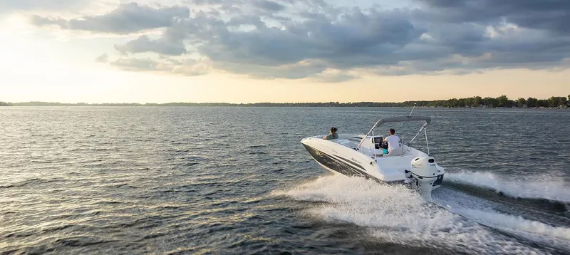 Slide: The Image of 2021 Hurricane 188 SunDeck Sport CC-OB cruising on a serene lake at sunset. - 16