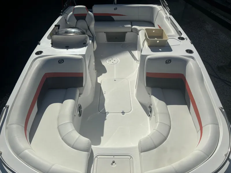 Slide: The Image of 2021 Hurricane 188 SunDeck Sport CC-OB boat interior with white seating and red accents. - 8