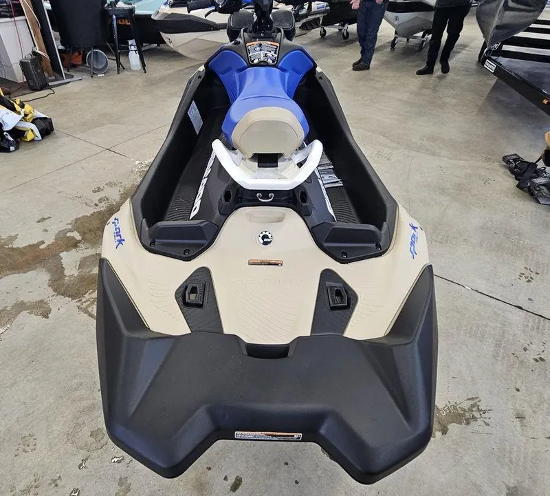 Slide: The Image of 2025 Sea-Doo Spark Trixx jet ski, blue seat, indoor showroom display. - 6