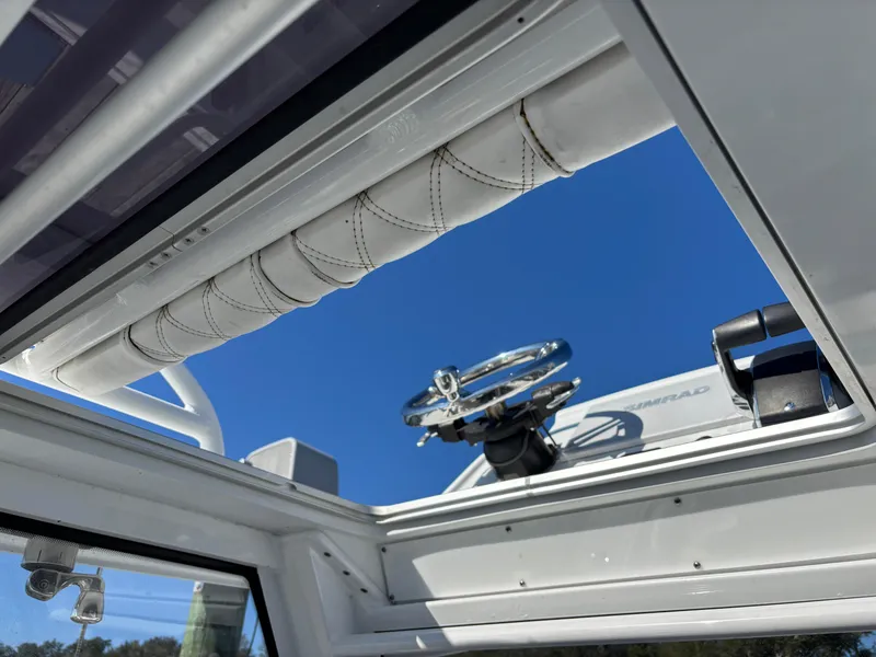 Slide: The Image of View of Costa Custom Boats 264HC helm through open hatch, 2022 model. - 11
