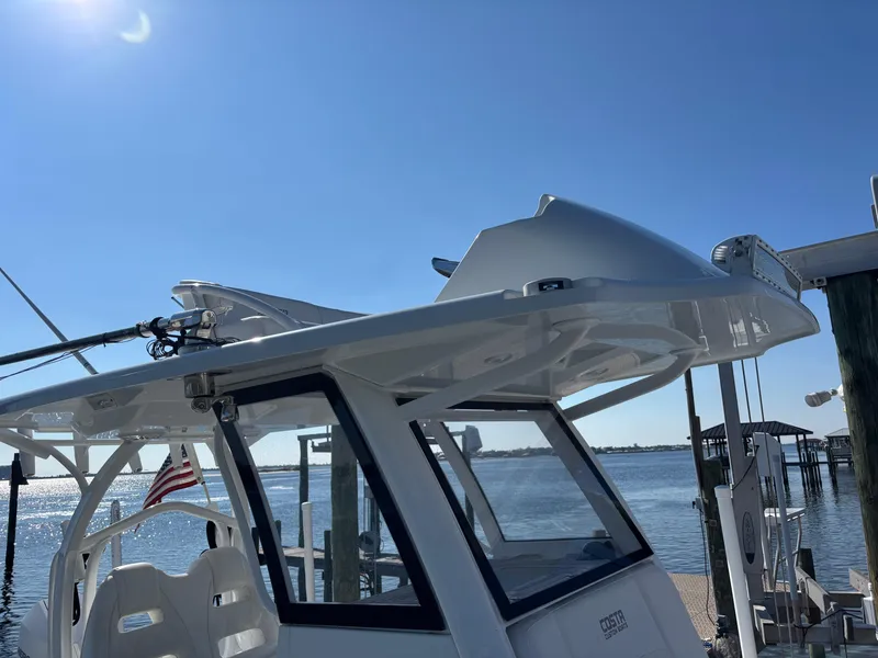Slide: The Image of 2022 Costa Custom Boats 264HC docked under clear blue sky. - 2
