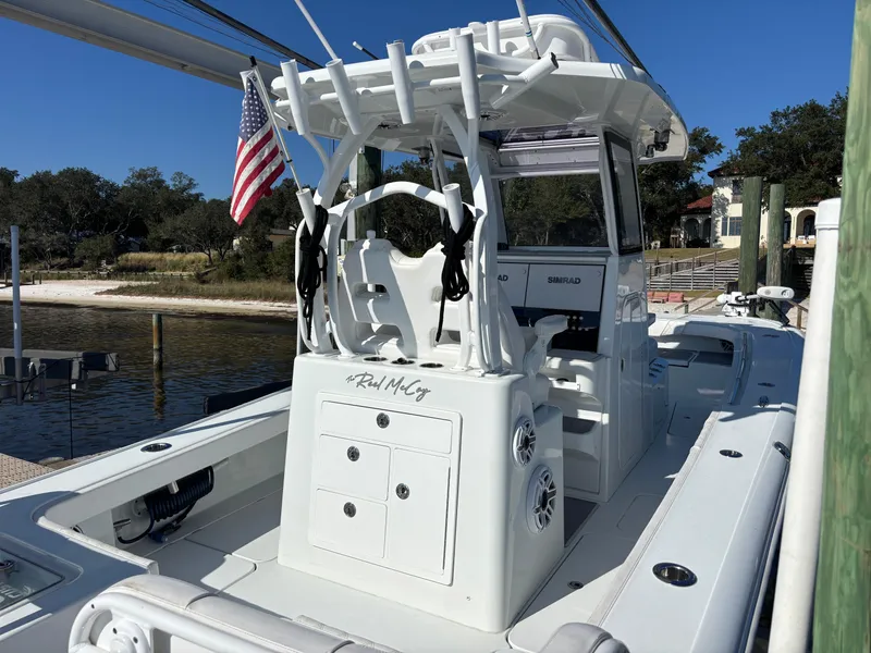 Slide: The Image of 2022 Costa Custom Boats 264HC, sleek white design, docked with American flag. - 20