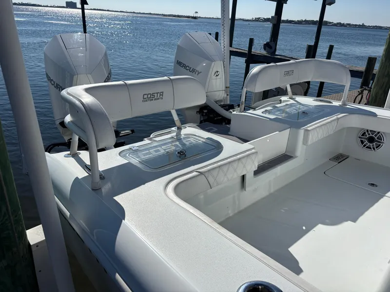 Slide: The Image of 2022 Costa Custom Boats 264HC with Mercury engines docked by the water. - 25