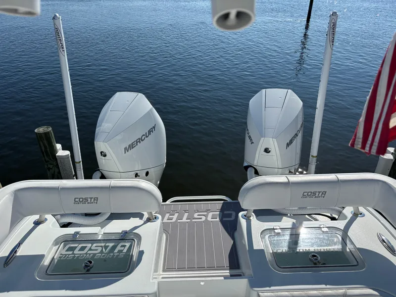 Slide: The Image of Costa Custom Boats 264HC 2022 with twin Mercury engines on calm water. - 26