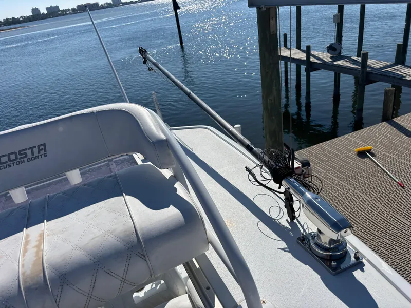 Slide: The Image of 2022 Costa Custom Boats 264HC on water, featuring deck and fishing equipment. - 31