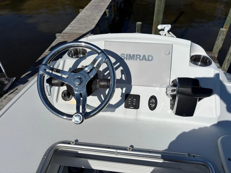 Slide: The Image of 2022 Costa Custom Boats 264HC helm with Simrad display and steering wheel. - 36