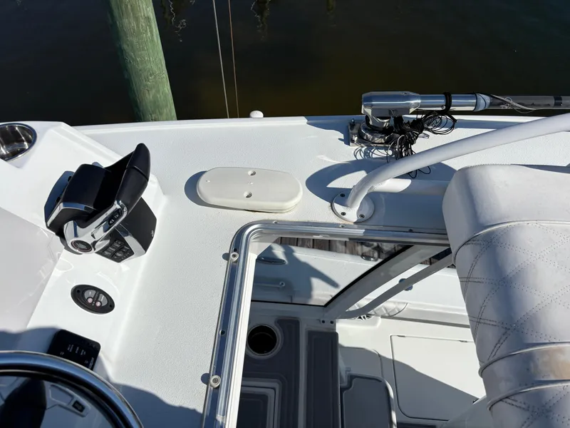 Slide: The Image of 2022 Costa Custom Boats 264HC cockpit with steering wheel and control panel. - 38
