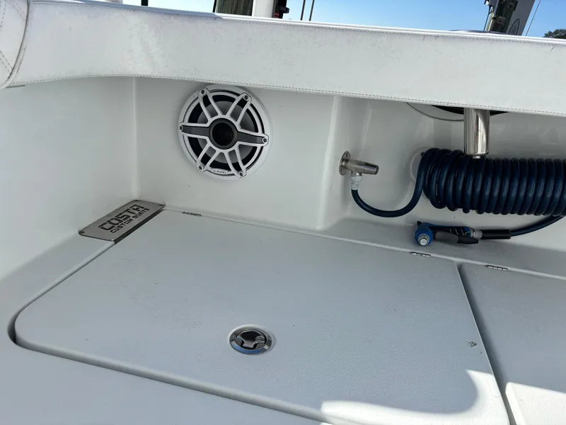 Slide: The Image of 2022 Costa Custom Boats 264HC deck with speaker and coiled hose. - 47