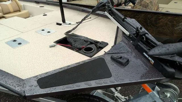 Slide: The Image of 2025 G3 Sportsman 1710 boat deck with wet surface and trolling motor. - 2