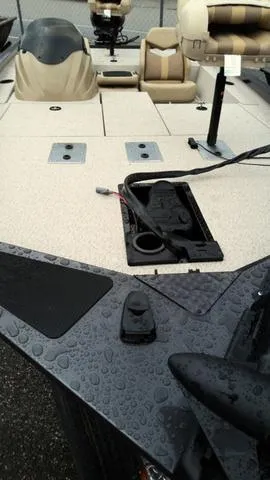Slide: The Image of 2025 G3 Sportsman 1710 boat deck with seating and equipment, wet from rain. - 3