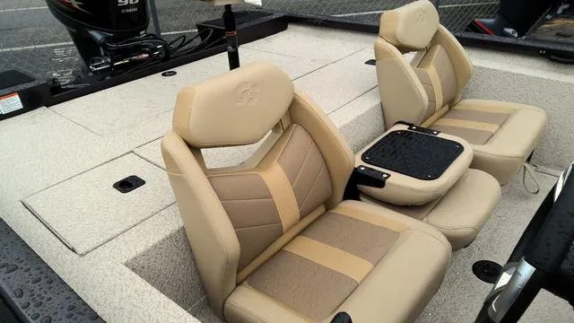 Slide: The Image of 2025 G3 Sportsman 1710 boat interior with beige seats and motor. - 5