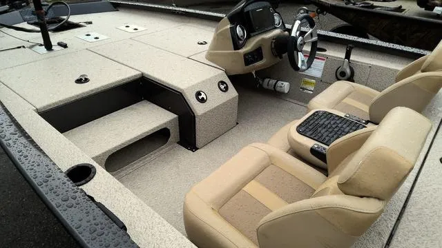 Slide: The Image of 2025 G3 Sportsman 1710 boat interior with beige seats and modern dashboard. - 7