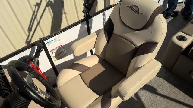 Slide: The Image of 2025 SunCatcher Select 324SL boat seat, beige and brown design, with steering wheel. - 15