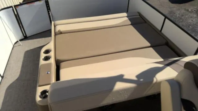 Slide: The Image of 2025 SunCatcher Select 324SL boat interior with beige seating and cup holders. - 17