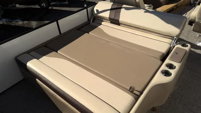 Slide: The Image of 2025 SunCatcher Select 324SL boat with beige seating and cup holders. - 18