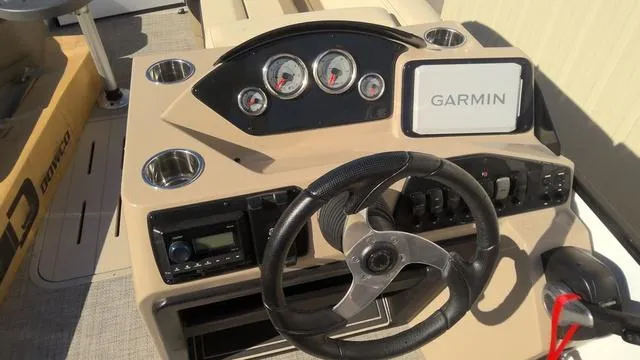 Slide: The Image of 2025 SunCatcher Select 324SL boat dashboard with Garmin navigation system and steering wheel. - 8
