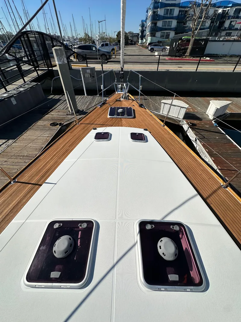 Slide: The Image of 2013 Jeanneau 57 yacht deck with hatches, docked in marina. - 15