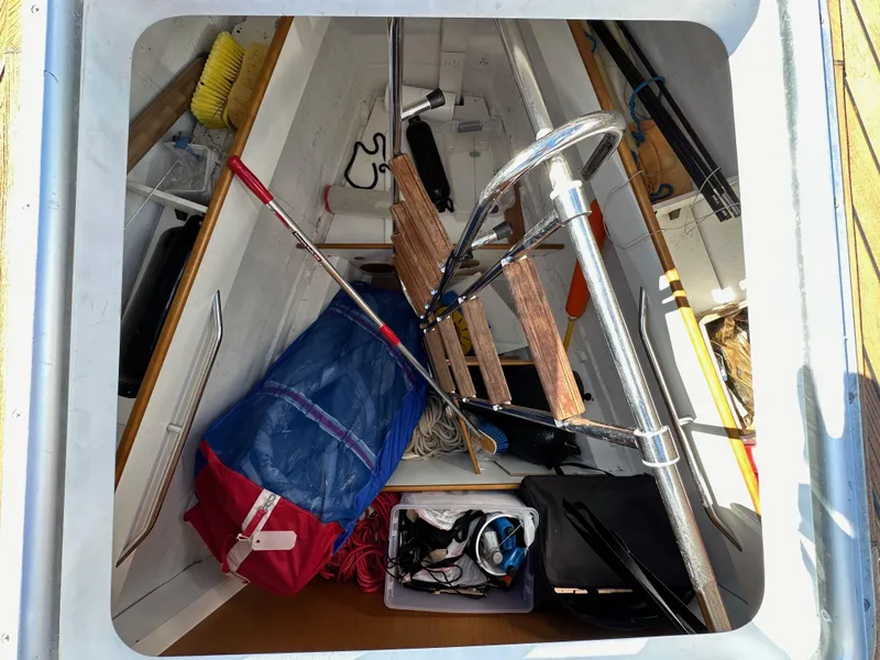 Slide: The Image of Storage compartment of a 2013 Jeanneau 57 sailboat with various equipment and gear. - 17