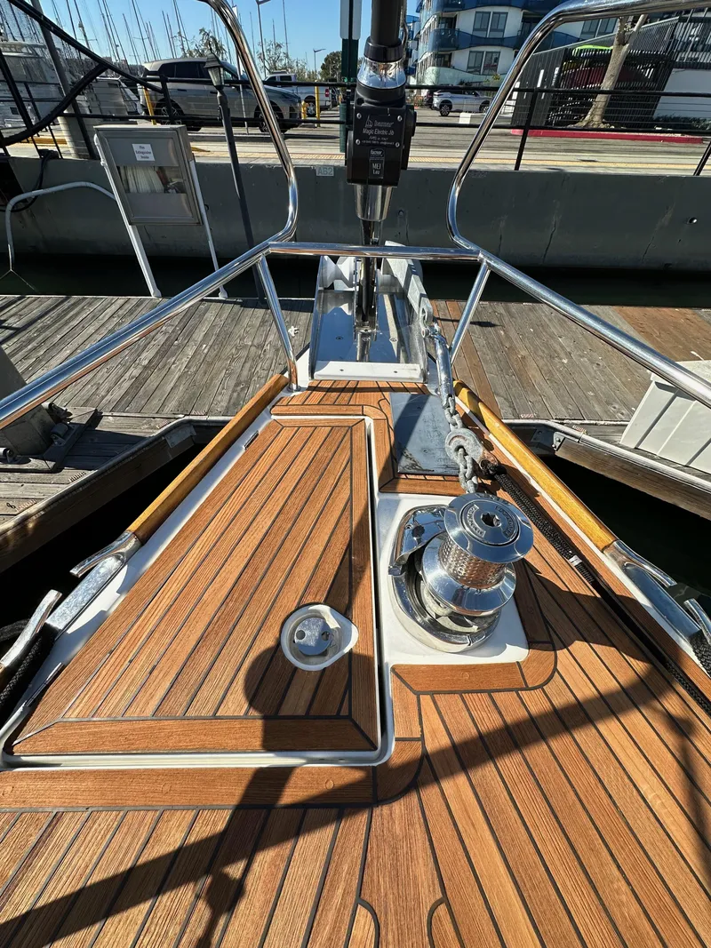 Slide: The Image of Jeanneau 57 sailboat deck, 2013 model, featuring teak wood and stainless steel fittings. - 19