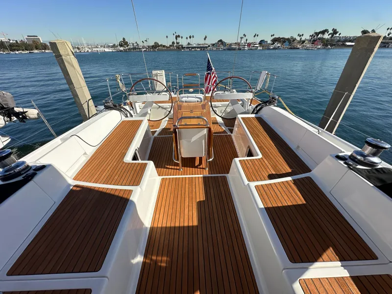 Slide: The Image of 2013 Jeanneau 57 yacht with teak deck, docked in a marina. - 28