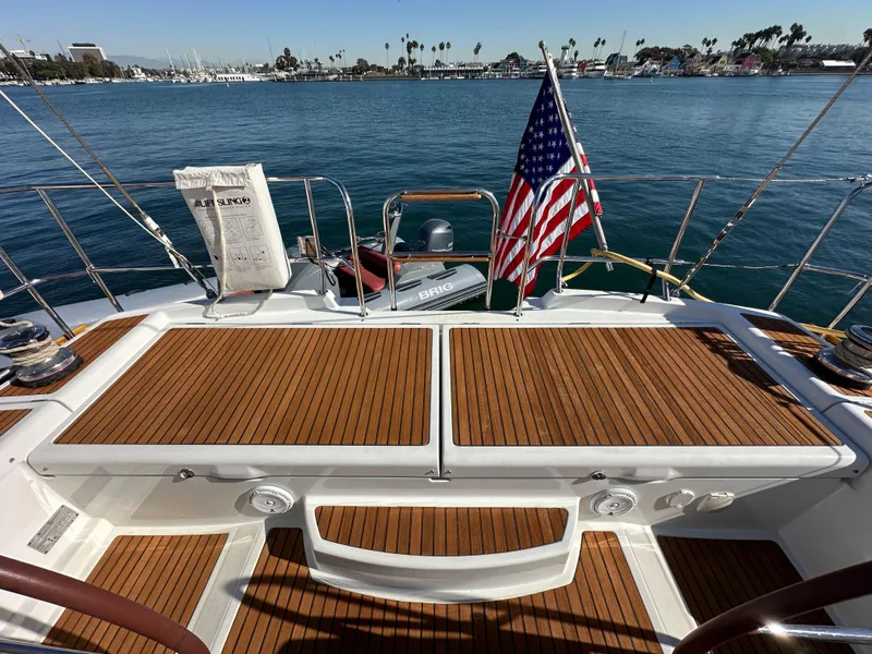 Slide: The Image of Jeanneau 57 sailboat deck, 2013 model, with American flag, docked in a marina. - 32