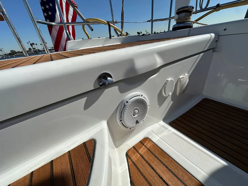 Slide: The Image of Jeanneau 57 yacht deck, 2013 model, featuring teak flooring and audio speaker. - 35