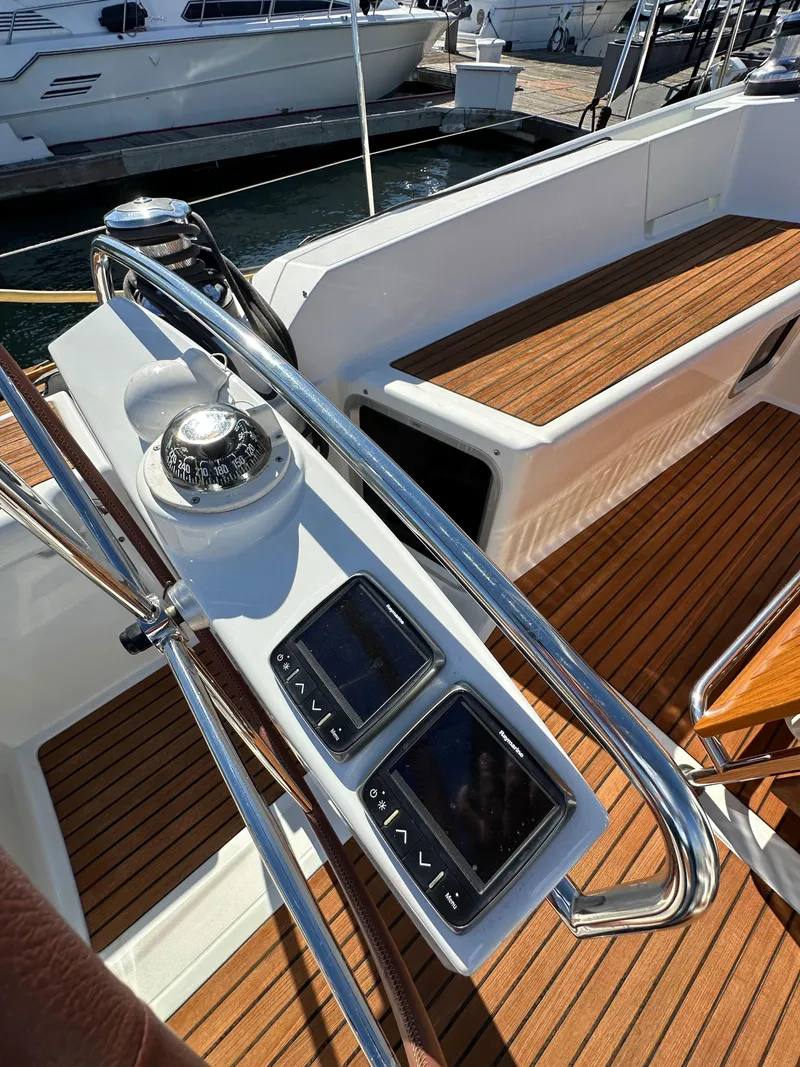 Slide: The Image of Jeanneau 57 yacht cockpit with navigation instruments, teak flooring, and steering wheel, 2013 model. - 37