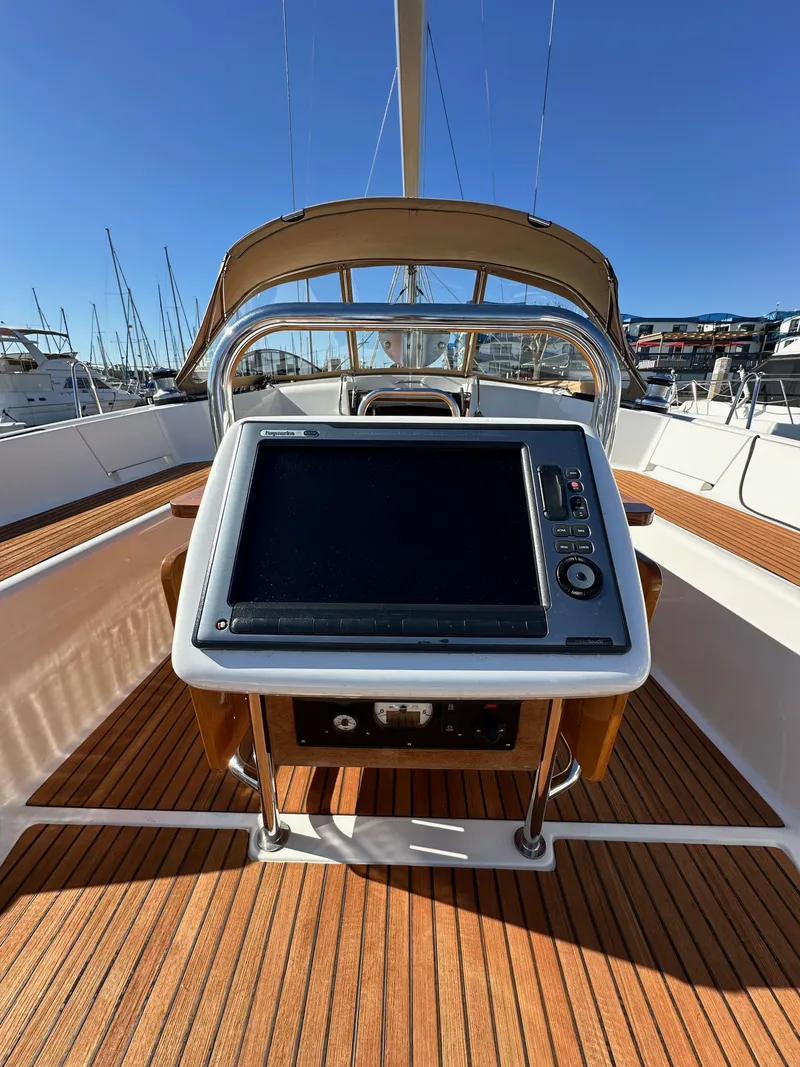 Slide: The Image of 2013 Jeanneau 57 yacht helm with navigation system and teak deck. - 38