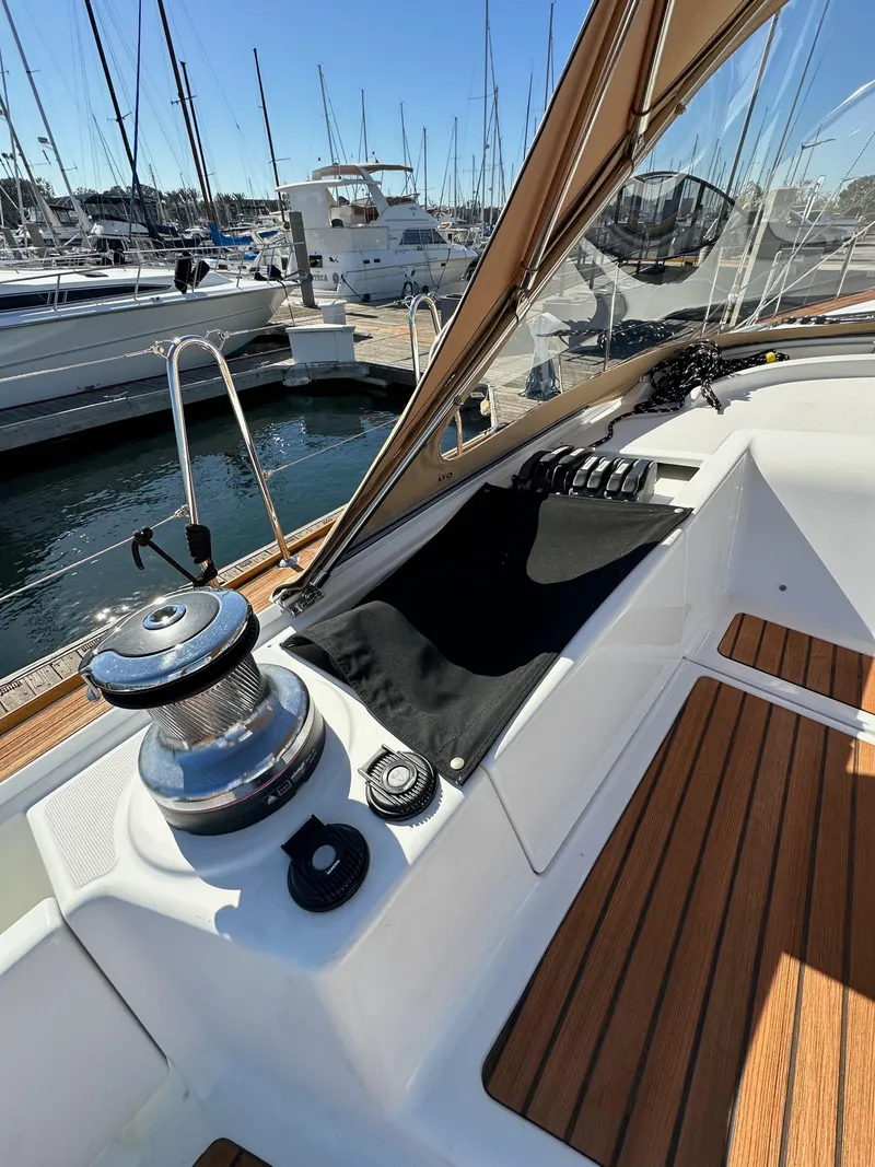 Slide: The Image of 2013 Jeanneau 57 yacht deck with winch and wooden flooring at marina. - 49