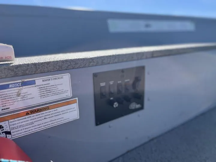 Slide: The Image of Control panel and safety notices on 2018 G3 Guide V150 T boat. - 11