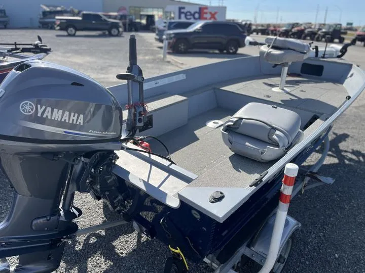 Slide: The Image of 2018 G3 Guide V150 T boat with Yamaha motor in parking lot. - 3