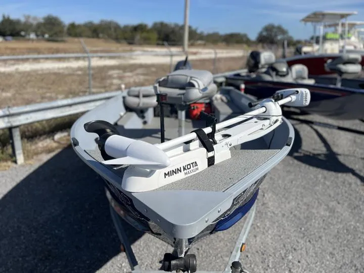 Slide: The Image of 2018 G3 Guide V150 T boat with Minn Kota motor, parked outdoors. - 7