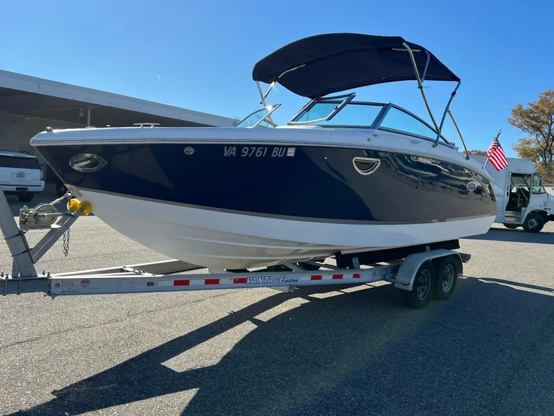Slide: The Image of 2014 Cobalt R5 boat on trailer with canopy, parked outdoors. - 14