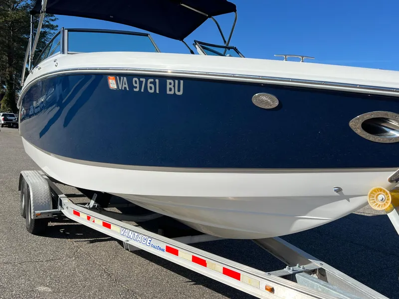 Slide: The Image of 2014 Cobalt R5 boat on trailer, blue and white exterior, sunny day. - 16