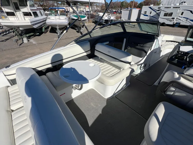 Slide: The Image of 2014 Cobalt R5 boat interior with white seating and round table. - 25