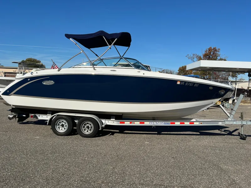 Slide: The Image of 2014 Cobalt R5 boat on trailer, parked outdoors under clear blue sky. - 3